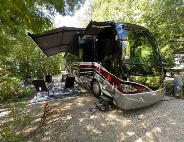 Multiple slide-outs and a massive awning allow for comfort inside and out while traveling in this diesel pusher