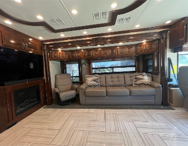 Along with 3 AC units, leather couches, heated tile flooring, and captains' chairs add to elegance and comfort while traveling in this Diesel pusher RV at fair rv market value
