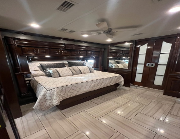 King bed, ceiling fan, and plenty of storage compliment the heated tile floor to make this Diesel Pushers master bedroom feel like home for fair market value