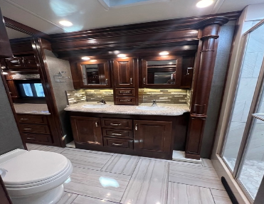 Master bath boasts dual sinks and mirrors, while providing plenty of space for a full shower in this for sale by owner great value diesel pusher