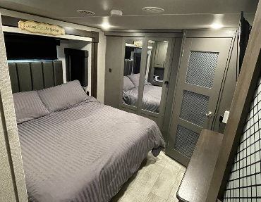 5th Wheel toy hauler features a king-sized bed in master bedroom