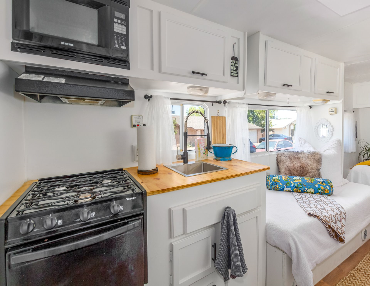 3-burner stove and fully remodeled kitchen allow the luxuries of home to travel with you in this Coachmen travel trailer