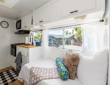 Window space, accompanied by a skylight in the unit, provides natural light while enjoying the comforts of this trailer