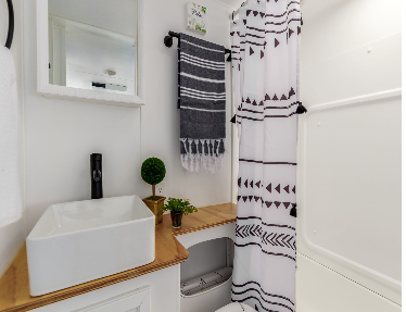 Fully remodeled bathroom is elegant and modern, while retaining space and functionality in this custom Coachmen travel trailer